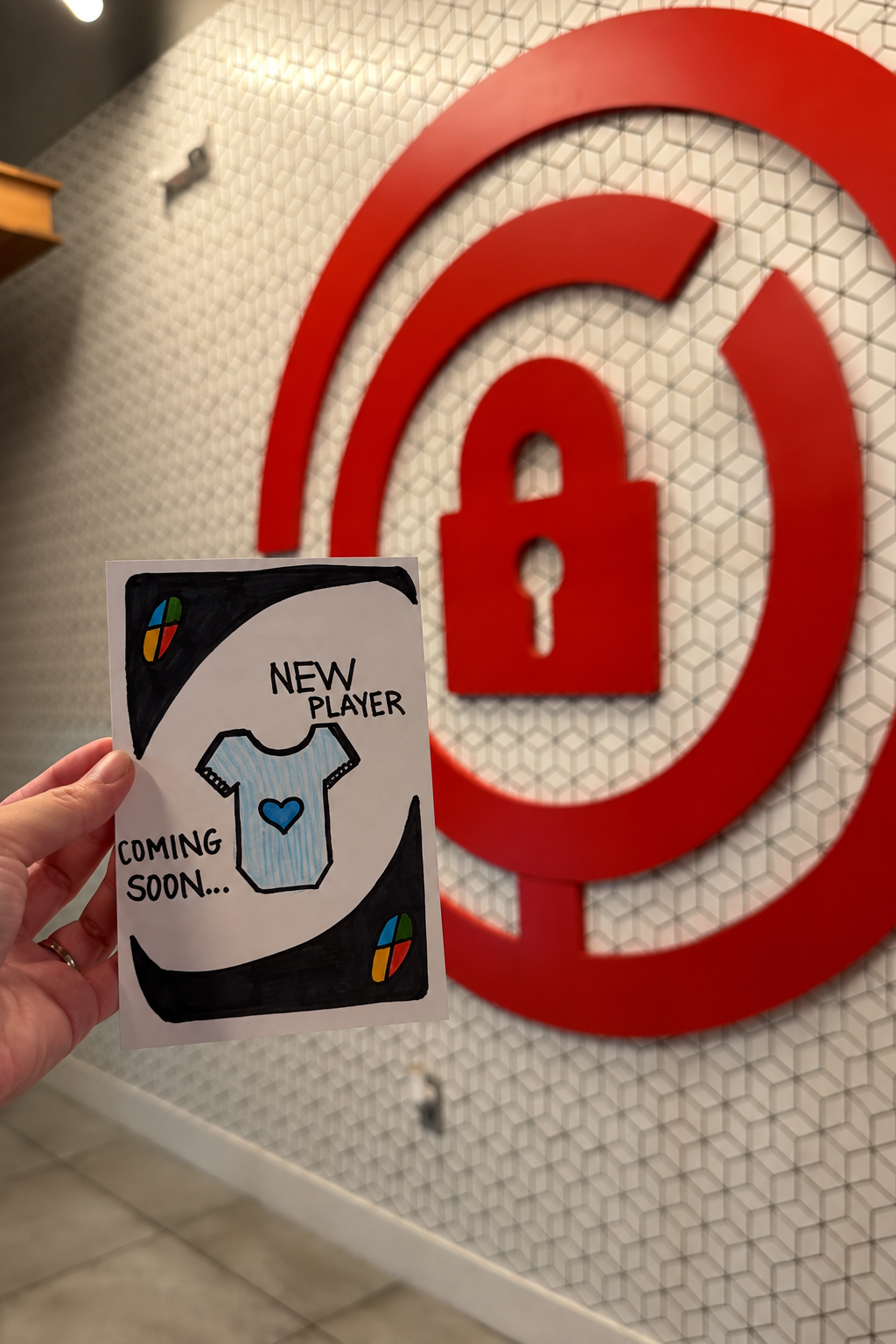 A hand-drawn Uno card reading New Player Coming Soon with a blue baby onesie